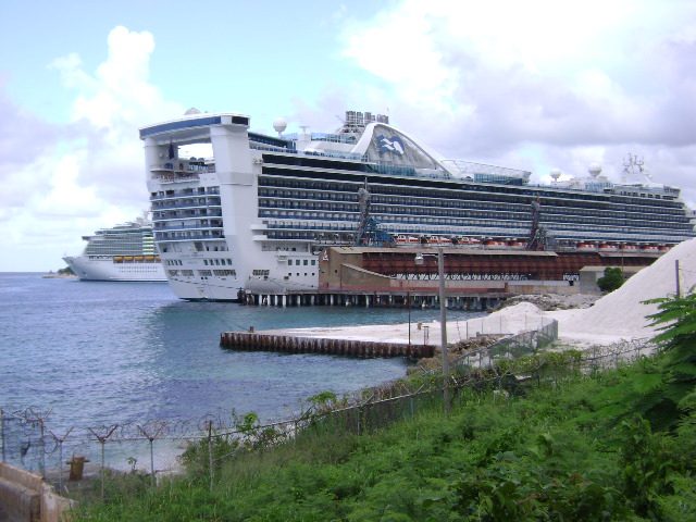 A large cruise ship docked at a Caribbean port