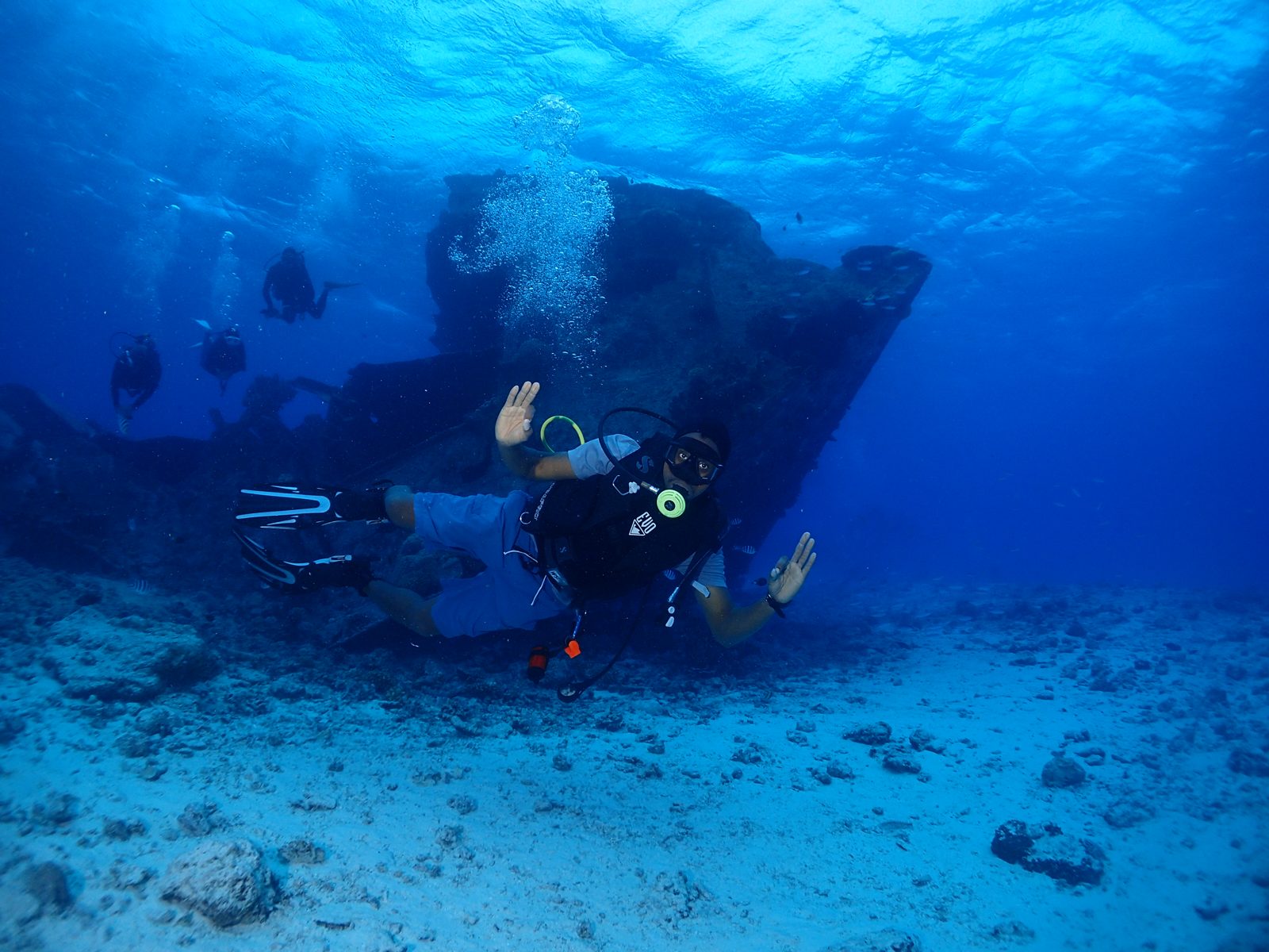 Peter Edwards diving beside a shipwreck on a coral reef